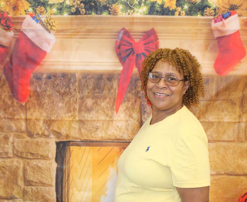 Woman standing in front of Christmas backdrop